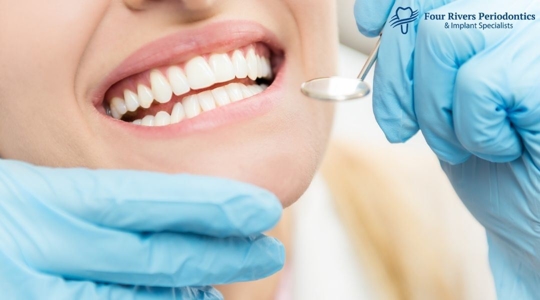 Close up of a dental patient smiling with dental mirror near her mouth