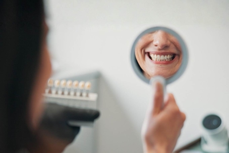 Patient in a dental clinic smiling in a mirror