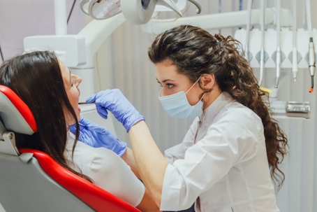 Young woman sitting in a dental chair for appointment
